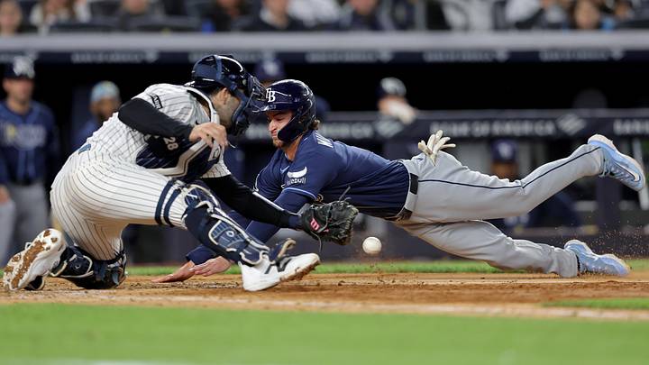 May 22, 2026; Bronx, New York, USA; Tampa Bay Rays pinch runner Carson Williams (7) scores from third on a sacrifice fly by right fielder Ryan Vilade (26) as New York Yankees catcher Austin Wells (28) drops the ball during the eighth inning at Yankee Stadium. May 22, 2026; Bronx, New York, USA; Tampa Bay Rays pinch runner Carson Williams (7) scores from third on a sacrifice fly by right fielder Ryan Vilade (26) as New York Yankees catcher Austin Wells (28) drops the ball during the eighth inning at Yankee Stadium.