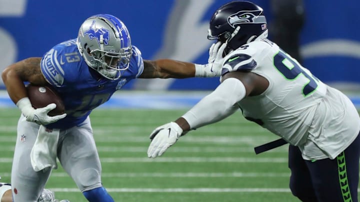 Sep 17, 2023; Detroit, Michigan, USA; Detroit Lions running back Craig Reynolds (13) is tackled by Seattle Seahawks defensive tackle Cameron Young (93) during the second half at Ford Field.