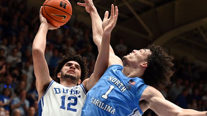 Mar 7, 2026; Durham, North Carolina, USA; Duke Blue Devils forward Cameron Boozer (12) shoots over North Carolina Tar Heels forward Zayden High (1) during the second half at Cameron Indoor Stadium.  The Duke Blue Devils won 76-61. Mandatory Credit: Rob Kinnan-Imagn Images