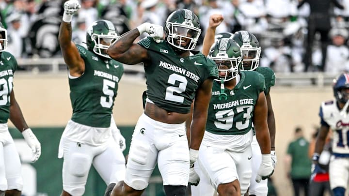 Michigan State's Khris Bogle, center, celebrates his stop against Florida Atlantic during the first quarter on Friday, Aug. 30, 2024, at Spartan Stadium in East Lansing.