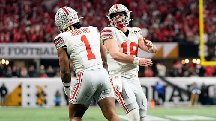Ohio State Buckeyes quarterback Will Howard (18) celebrates a touchdown with running back Quinshon Judkins (1) against Notre Dame Fighting Irish in the second quarter during the College Football Playoff National Championship at Mercedes-Benz Stadium in Atlanta on January 20, 2025. Ohio State Buckeyes quarterback Will Howard (18) celebrates a touchdown with running back Quinshon Judkins (1) against Notre Dame Fighting Irish in the second quarter during the College Football Playoff National Championship at Mercedes-Benz Stadium in Atlanta on January 20, 2025.