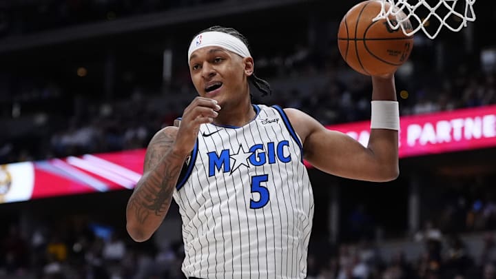 Dec 18, 2025; Denver, Colorado, USA; Orlando Magic forward Paolo Banchero (5) grabs a rebound in the first quarter against the Denver Nuggets at Ball Arena. Mandatory Credit: Ron Chenoy-Imagn Images