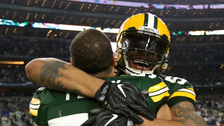 Julius Peppers embraces Nick Perry after the Packers won a playoff game at Dallas.