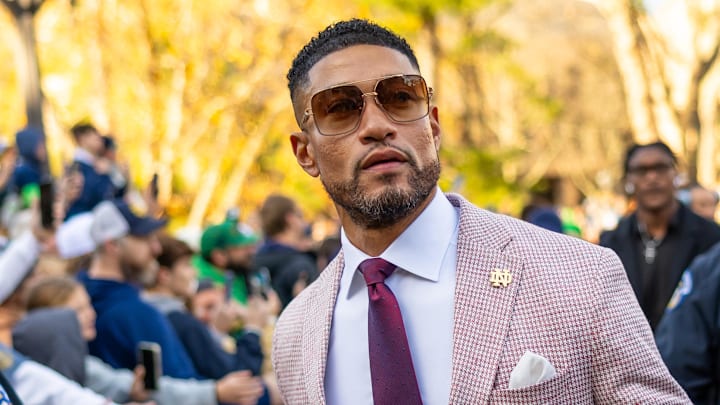 Nov 22, 2025; South Bend, Indiana, USA; Notre Dame Fighting Irish head coach Marcus Freeman greets fans while walking to the stadium before facing the Syracuse Orange at Notre Dame Stadium. 