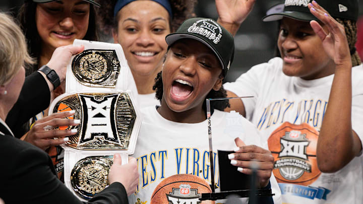 Mar 8, 2026; Kansas City, MO, USA; West Virginia Mountaineers guard Jordan Harrison (10) accepts the player of the game trophy after the game against the TCU Horned Frogs at T-Mobile Center. Mandatory Credit: William Purnell-Imagn Images