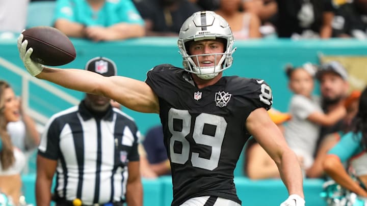 Nov 17, 2024; Miami Gardens, Florida, USA; Las Vegas Raiders tight end Brock Bowers (89) scores a touchdown past Miami Dolphins safety Jevon Holland (8) in the third quarter at Hard Rock Stadium. Mandatory Credit: Jim Rassol-Imagn Images