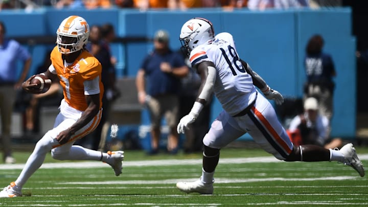 Tennessee Volunteers quarterback Joe Milton III (7) eludes Virginia Cavaliers defensive tackle Michael Diatta (18) during their game at Nissan Stadium Saturday, Sept. 2, 2023.