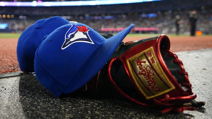 May 10, 2024; Toronto, Ontario, CAN; A pair of Toronto Blue Jays hats and glove in the dugout during a game against the Minnesota Twins at Rogers Centre.