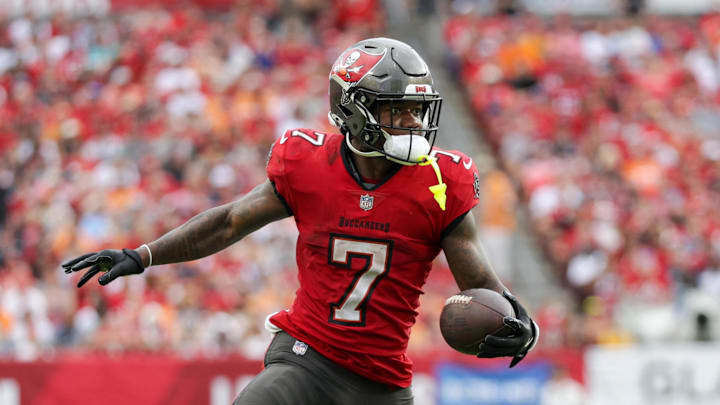 Dec 29, 2024; Tampa, Florida, USA; Tampa Bay Buccaneers running back Bucky Irving (7) runs with the ball against the Carolina Panthers in the third quarter at Raymond James Stadium. Mandatory Credit: Nathan Ray Seebeck-Imagn Images