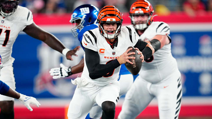 Cincinnati Bengals quarterback Joe Burrow (9) runs past the New York Giants defense as he begins his touchdown run to score the first points of the game, Sunday, October 13, 2024, in East Rutherford.
