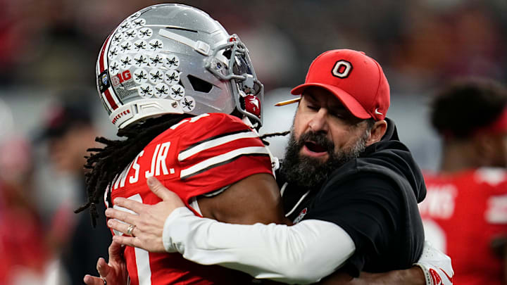 Ohio State Buckeyes defensive coordinator Matt Patricia hugs cornerback Jermaine Mathews Jr. (7) during warm-ups prior to the Cotton Bowl at AT&T Stadium in Arlington, Texas for the College Football Playoff quarterfinal game against the Miami Hurricanes on Dec. 31, 2025.