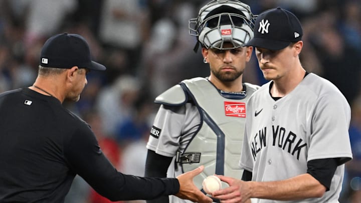 Jul 23, 2025; Toronto, Ontario, CAN;  New York Yankees manager Aaron Boone (17) takes the ball from pitcher Max Fried (54) in the sixth inning against the Toronto Blue Jays at Rogers Centre. Mandatory Credit: Dan Hamilton-Imagn Images