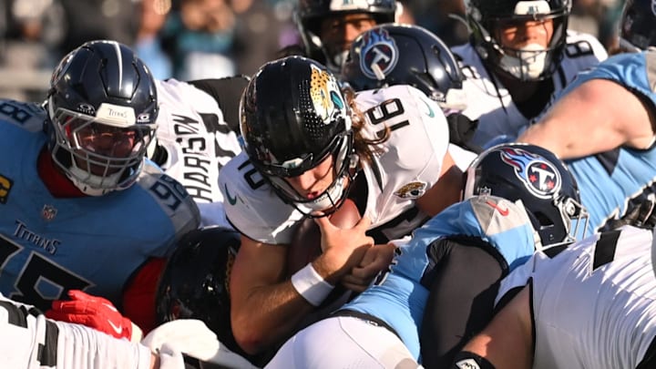 Nov 30, 2025; Nashville, Tennessee, USA; Jacksonville Jaguars quarterback Trevor Lawrence (16) carries the ball for a first down against the Tennessee Titans during the second half at Nissan Stadium. Mandatory Credit: Steve Roberts-Imagn Images