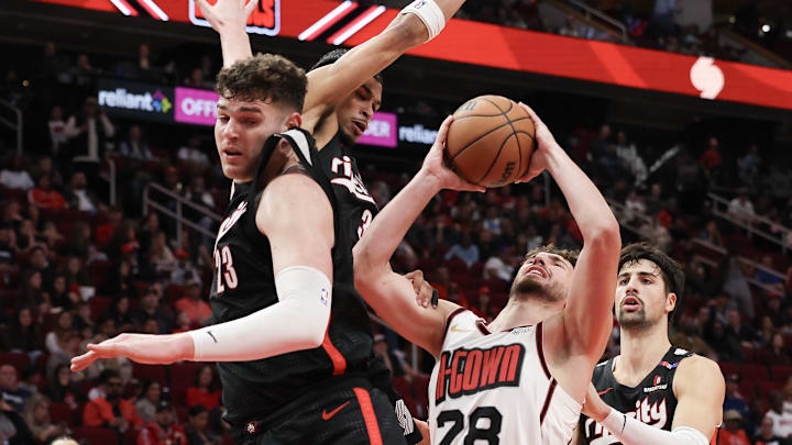 Nov 23, 2024; Houston, Texas, USA; Houston Rockets center Alperen Sengun (28) shoots against Portland Trail Blazers center Donovan Clingan (23) and teammates in the second quarter at Toyota Center. Mandatory Credit: Thomas Shea-Imagn Images