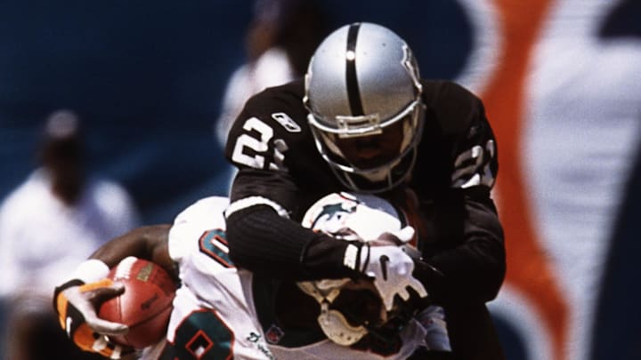 Sep 23, 2001; Miami, FL, USA; FILE PHOTO; Miami Dolphins receiver James McKnight (80) in action against Oakland Raiders defensive back Eric Allen (21) at Pro Player Stadium. Mandatory Credit: Lou Capozzola-USA TODAY NETWORK