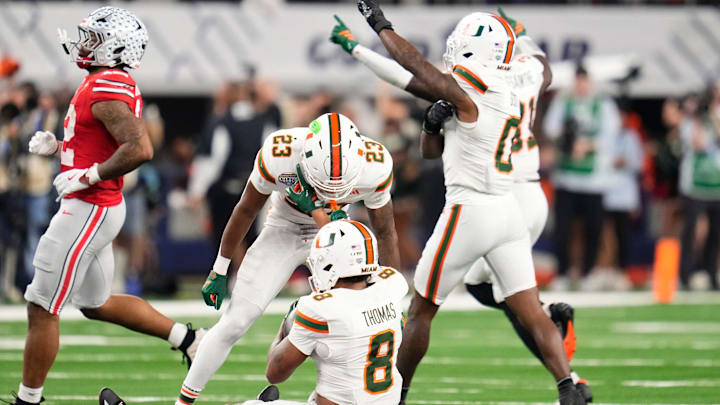 Miami Hurricanes defensive back Jakobe Thomas (8) celebrates an interception with defensive back Dylan Day (23) to seal the Cotton Bowl at AT&T Stadium in Arlington, Texas for the College Football Playoff quarterfinal game against the Ohio State Buckeyes on Dec. 31, 2025. Ohio State lost 24-14.