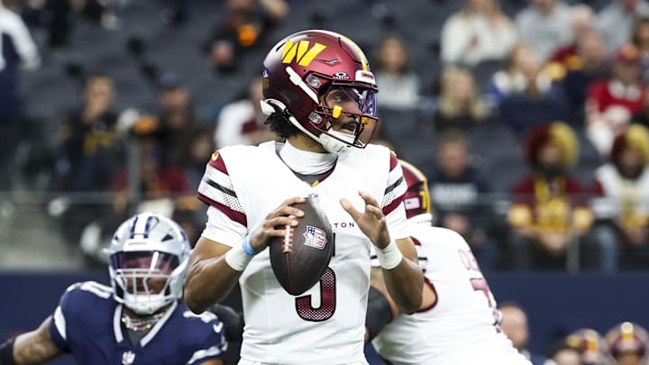 Jan 5, 2025; Arlington, Texas, USA;  Washington Commanders quarterback Jayden Daniels (5) throws as Dallas Cowboys linebacker Micah Parsons (11) chases during the first quarter at AT&T Stadium. Mandatory Credit: Kevin Jairaj-Imagn Images