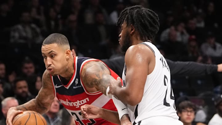 Oct 14, 2024; Brooklyn, New York, USA; Washington Wizards small forward Kyle Kuzma (33) dribbles the ball against Brooklyn Nets small guard Cam Thomas (24) during the second half at Barclays Center. Mandatory Credit: Gregory Fisher-Imagn Images