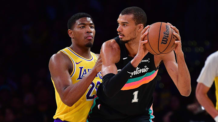 Feb 10, 2026; Los Angeles, California, USA; San Antonio Spurs forward Victor Wembanyama (1) moves the ball against Los Angeles Lakers forward Rui Hachimura (28) during the first half at Crypto.com Arena.