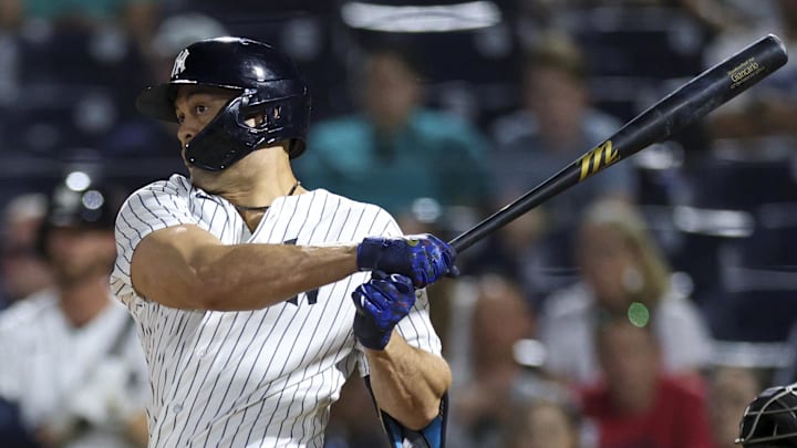 Mar 9, 2026; Tampa, Florida, USA; New York Yankees designated hitter Giancarlo Stanton (27) singles against the Pittsburgh Pirates in the sixth inning during spring training at George M. Steinbrenner Field. Mandatory Credit: Nathan Ray Seebeck-Imagn Images