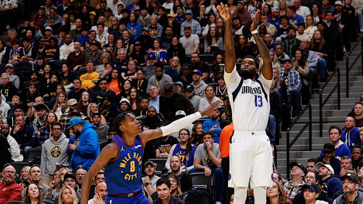 Nov 22, 2024; Denver, Colorado, USA; Dallas Mavericks forward Naji Marshall (13) attempts a shot as Denver Nuggets forward Peyton Watson (8) defends in the third quarter at Ball Arena. Mandatory Credit: Isaiah J. Downing-Imagn Images