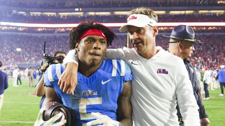 Nov 15, 2025; Oxford, Mississippi, USA; Mississippi Rebels head coach Lane Kiffin embraces running back Kewan Lacy (5) after defeating the Florida Gators at Vaught-Hemingway Stadium. Mandatory Credit: Petre Thomas-Imagn Images