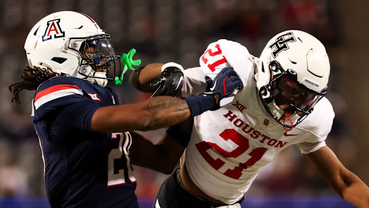 Nov 15, 2024; Tucson, Arizona, USA; Arizona Wildcats defensive back Marquis Groves-Killebrew (20) shoves Houston Cougars running back Stacy Sneed (21) during the third quarter at Arizona Stadium. Mandatory Credit: Aryanna Frank-Imagn Images