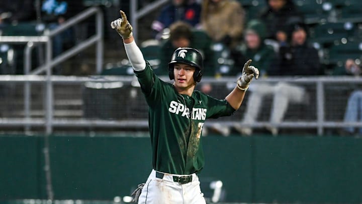 Michigan State's Randy Seymour, right, celebrates after scoring against the Lugnuts in the third inning on Tuesday, April 4, 2023, during the Crosstown Showdown at Jackson Field in Lansing.

230404 Msu Lugnuts Bsball 132a