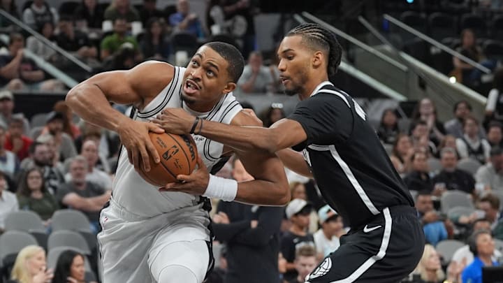 Oct 26, 2025; San Antonio, Texas, USA; San Antonio Spurs forward Keldon Johnson (3) drives in between Brooklyn Nets forward Noah Clowney (21) and Brooklyn Nets forward Ziaire Williams (1) in the first half at Frost Bank Center. Mandatory Credit: Daniel Dunn-Imagn Images Oct 26, 2025; San Antonio, Texas, USA; San Antonio Spurs forward Keldon Johnson (3) drives in between Brooklyn Nets forward Noah Clowney (21) and Brooklyn Nets forward Ziaire Williams (1) in the first half at Frost Bank Center. Mandatory Credit: Daniel Dunn-Imagn Images