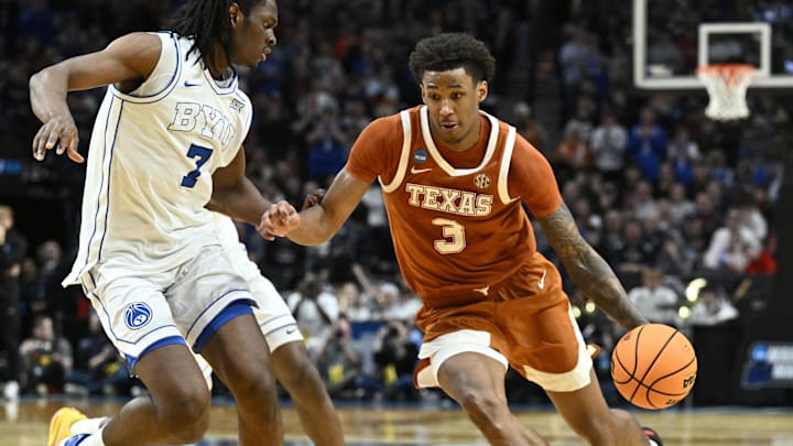 Texas Longhorns forward Dailyn Swain drives against BYU Cougars forward Khadim Mboup in the second half during a first-round game of the men's 2026 NCAA Tournament at Moda Center. Texas Longhorns forward Dailyn Swain drives against BYU Cougars forward Khadim Mboup in the second half during a first-round game of the men's 2026 NCAA Tournament at Moda Center.