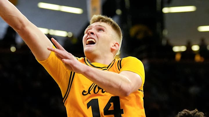 Iowa guard Bennett Stirtz (14) drives to the basket as Northwestern forward Tre Singleton (8) defends Feb. 8, 2026 at Carver-Hawkeye Arena in Iowa City, Iowa.