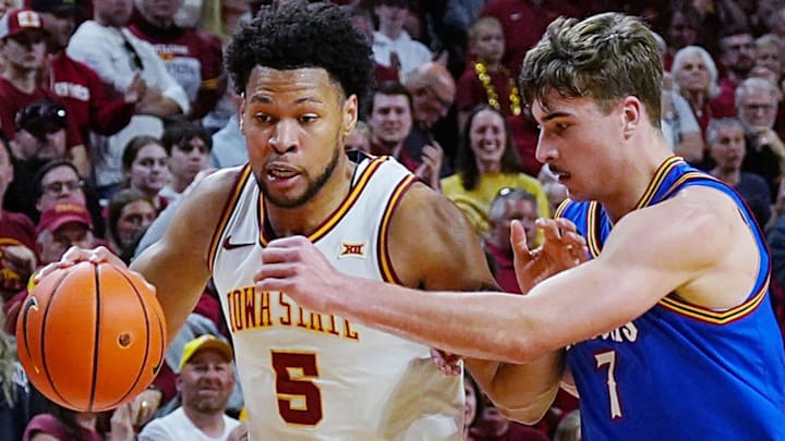 Iowa State Cyclones forward Joshua Jefferson (5) drives with the ball as Kansas Jayhawks guard Kohl Rosario (7) defends during the second half in the Big-12 conference basketball showdown on Feb. 14, 2026, at Hilton Coliseum, in Ames, Iowa.