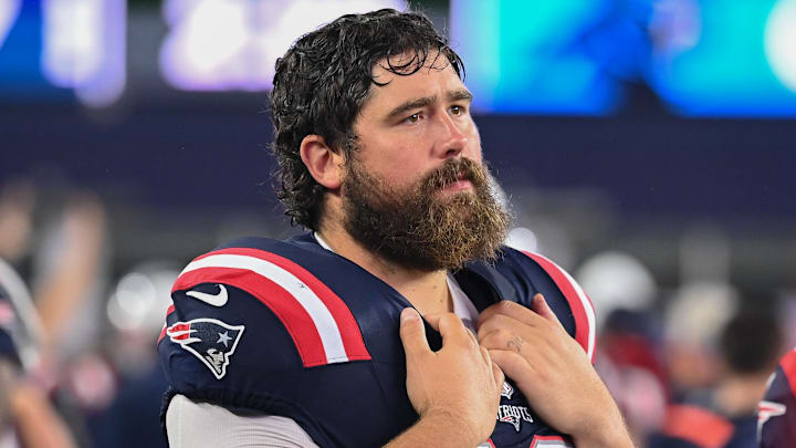 August 8, 2024; Foxborough, MA, USA;  New England Patriots center David Andrews (60) watches from the sideline during the first half against the Carolina Panthers at Gillette Stadium. Mandatory Credit: Eric Canha-Imagn Images
