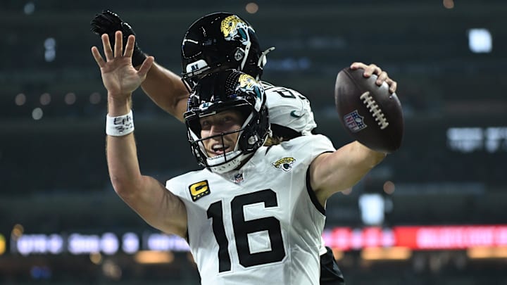 Dec 28, 2025; Indianapolis, Indiana, USA; Jacksonville Jaguars quarterback Trevor Lawrence (16) celebrates with tight end Brenton Strange (85) after a touchdown against the Indianapolis Colts during the first half at Lucas Oil Stadium. Mandatory Credit: Robert Goddin-Imagn Images