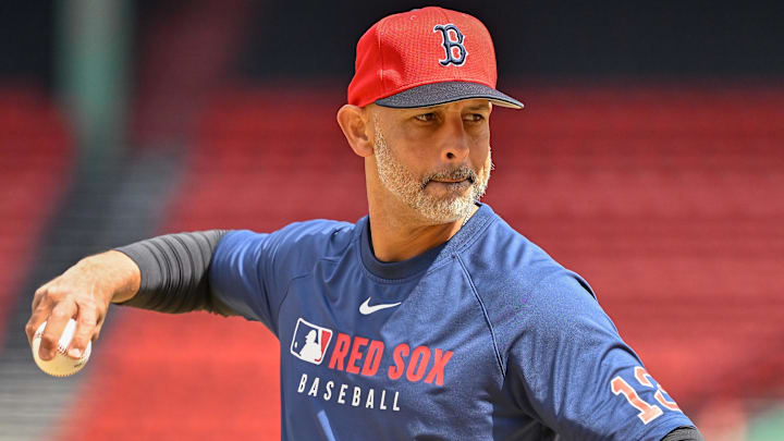 Boston Red Sox manager Alex Cora (13) pitches balls during batting practice before a game against the Toronto Blue Jays at Fenway Park.