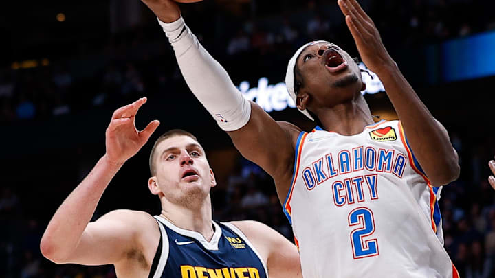 Mar 2, 2022; Denver, Colorado, USA; Oklahoma City Thunder guard Shai Gilgeous-Alexander (2) drives to the net against Denver Nuggets forward Will Barton (5) and center Nikola Jokic (15) in the fourth quarter at Ball Arena. Mandatory Credit: Isaiah J. Downing-Imagn Images