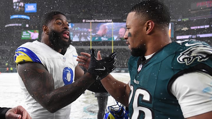 Jan 19, 2025; Philadelphia, Pennsylvania, USA; Los Angeles Rams linebacker Jared Verse (8) greets Philadelphia Eagles running back Saquon Barkley (26) after their 2025 NFC divisional round game at Lincoln Financial Field. Mandatory Credit: Eric Hartline-Imagn Images