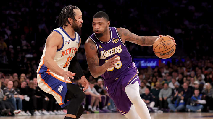 Feb 1, 2026; New York, New York, USA; Los Angeles Lakers guard Marcus Smart (36) controls the ball against New York Knicks guard Jalen Brunson (11) during the third quarter at Madison Square Garden. Mandatory Credit: Brad Penner-Imagn Images