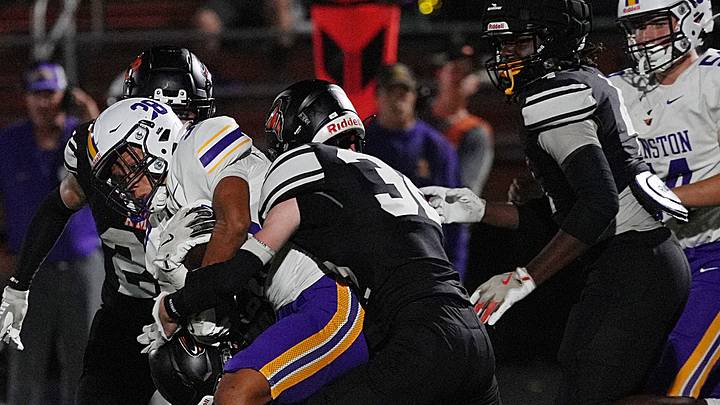 Ames’ defender Benton Winkey (32) takes down Johnston's running back Dante Davis (38) during the fourth quarter at Ames High Football field o, Sept 12, 2025, in Ames, Iowa Ames’ defender Benton Winkey (32) takes down Johnston's running back Dante Davis (38) during the fourth quarter at Ames High Football field o, Sept 12, 2025, in Ames, Iowa