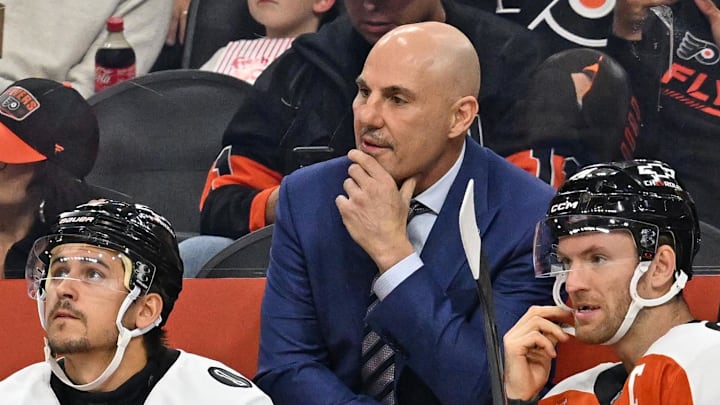 Oct 13, 2025; Philadelphia, Pennsylvania, USA; Philadelphia Flyers head coach Rick Tocchet with right wing Travis Konecny (11) and center Sean Couturier (14) against the Florida Panthers during the first period at Wells Fargo Center. Mandatory Credit: Eric Hartline-Imagn Images