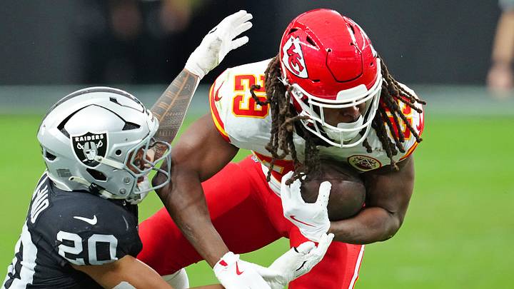 Jan 4, 2026; Paradise, Nevada, USA; Las Vegas Raiders safety Isaiah Pola-Mao (20) looks to tackle Kansas City Chiefs running back Kareem Hunt (29) during the second quarter at Allegiant Stadium. Mandatory Credit: Stephen R. Sylvanie-Imagn Images