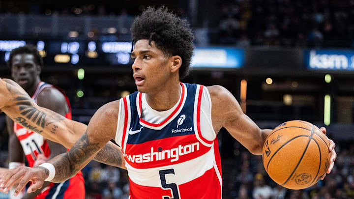 Apr 8, 2025; Indianapolis, Indiana, USA; Washington Wizards guard AJ Johnson (5) dribbles the ball while Indiana Pacers forward Obi Toppin (1) defends in the second half at Gainbridge Fieldhouse. Mandatory Credit: Trevor Ruszkowski-Imagn Images