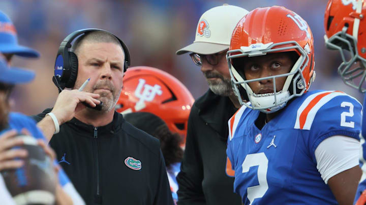Florida head coach Billy Napier talks with Florida quarterback DJ Lagway (2) during the first half of an NCAA football game at Steve Spurrier Field at Ben Hill Griffin Stadium in Gainesville, FL on Saturday, October 18, 2025. [Alan Youngblood/Gainesville Sun]