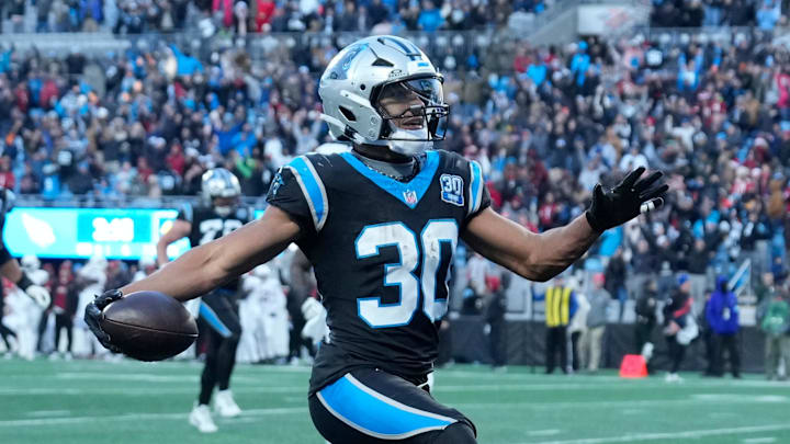 Dec 22, 2024; Charlotte, North Carolina, USA; Carolina Panthers running back Chuba Hubbard (30) scores in overtime to win the gqme at Bank of America Stadium. Mandatory Credit: Bob Donnan-Imagn Images