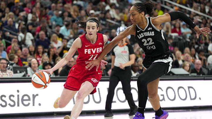 Jun 22, 2025; Las Vegas, Nevada, USA; Indiana Fever guard Caitlin Clark (22) dribbles the ball against Las Vegas Aces center A'ja Wilson (22) during the second half of a WNBA basketball game at T-Mobile Arena. Mandatory Credit: Lucas Peltier-Imagn Images