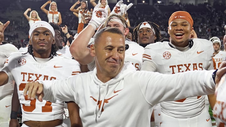 Oct 25, 2025; Starkville, Mississippi, USA; Texas Longhorns head coach Steve Sarkisian reacts with defensive linemen Colin Simmons (1) after beating the Mississippi State Bulldogs in overtime at Davis Wade Stadium at Scott Field. Mandatory Credit: Petre Thomas-Imagn Images