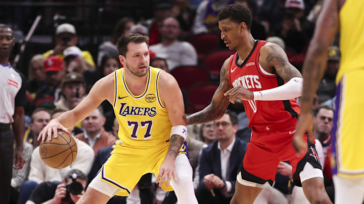 Mar 16, 2026; Houston, Texas, USA; Los Angeles Lakers guard Luka Doncic (77) controls the ball as Houston Rockets forward Jabari Smith Jr. (10) defends during the first quarter at Toyota Center. Mandatory Credit: Troy Taormina-Imagn Images