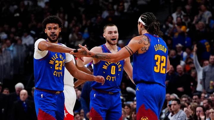 Mar 11, 2026; Denver, Colorado, USA; Denver Nuggets forward Cameron Johnson (23), guard Christian Braun (0) and forward Aaron Gordon (32) reacts in the third quarter against the Houston Rockets at Ball Arena. Mandatory Credit: Ron Chenoy-Imagn Images