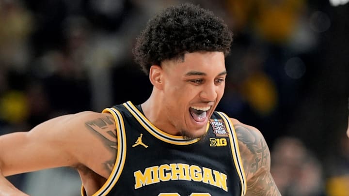 Michigan forward Yaxel Lendeborg (23) celebrates a play with Michigan guard Trey McKenney (1) in the first half of their Final Four game at Lucas Oil Stadium in Indianapolis on Saturday, April 4, 2026.