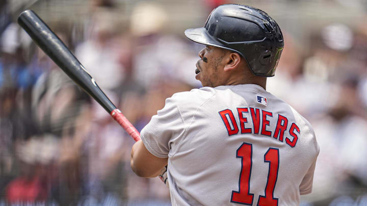 Jun 1, 2025; Cumberland, Georgia, USA; Boston Red Sox designated hitter Rafael Devers (11) follows through after hitting a double against the Atlanta Braves during the first inning at Truist Park. Mandatory Credit: Dale Zanine-Imagn Images